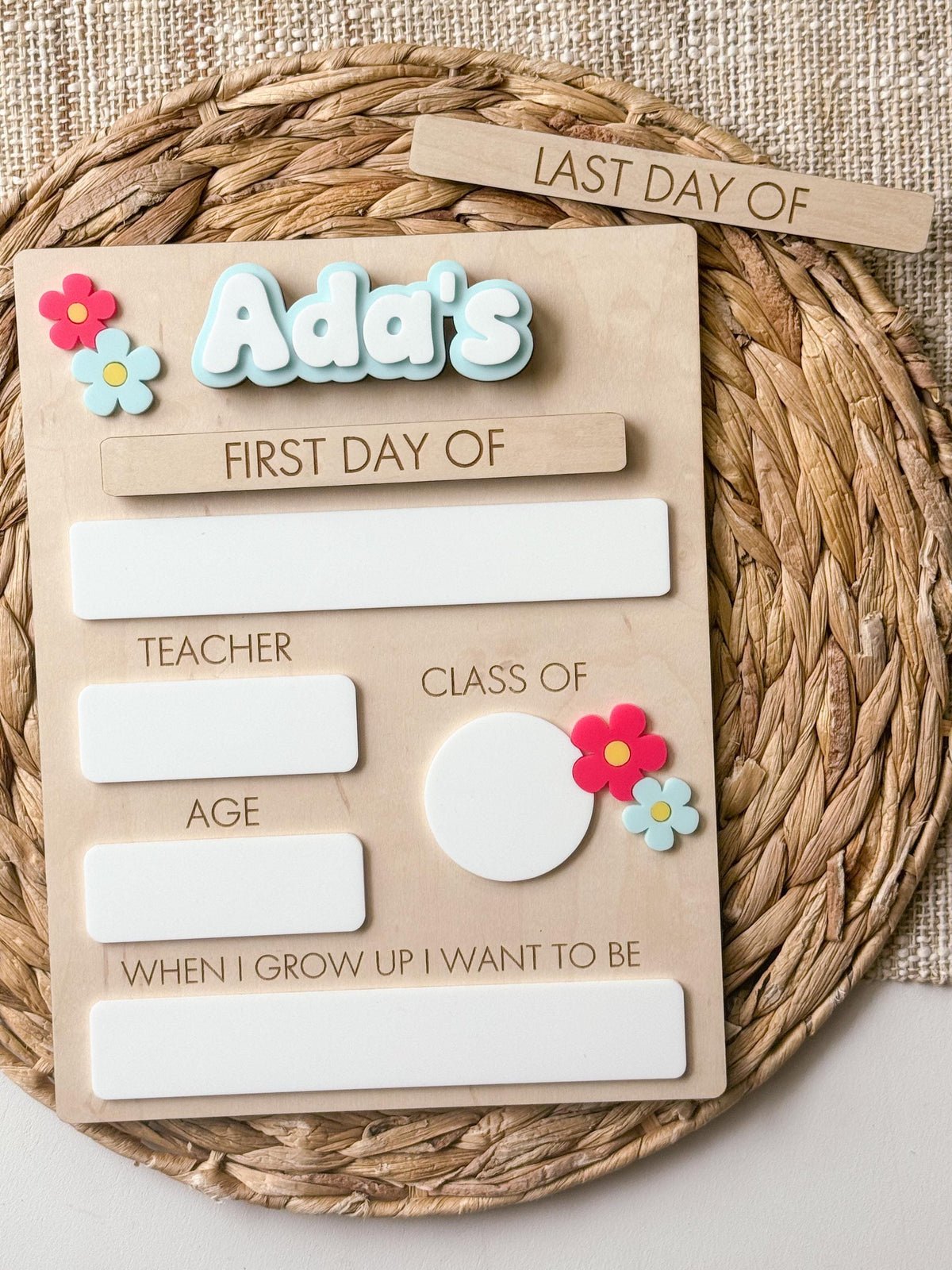Personalized daisy back to school sign with colorful acrylic name, first day of school piece and dry erase milestone spaces.