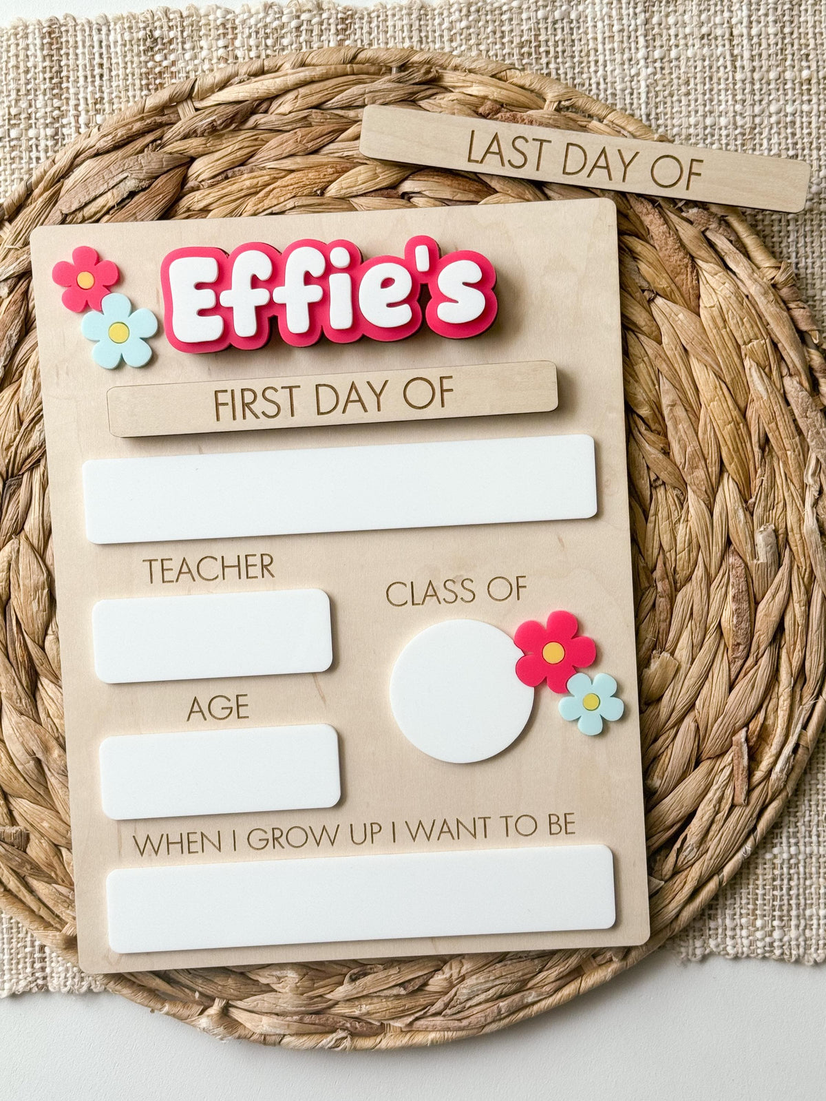 Personalized first day of school sign with pink acrylic name, daisy accents and reusable dry erase spaces.