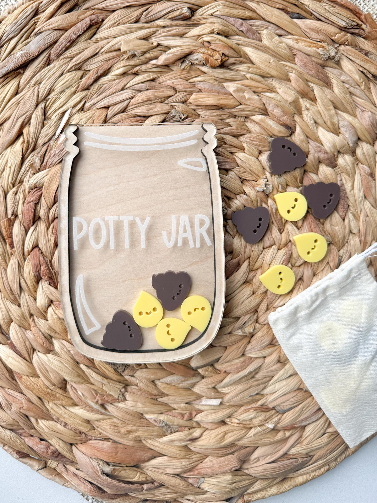 Potty training reward jar made of wood and clear acrylic with smiling pee drop and poop tokens and a cotton storage bag