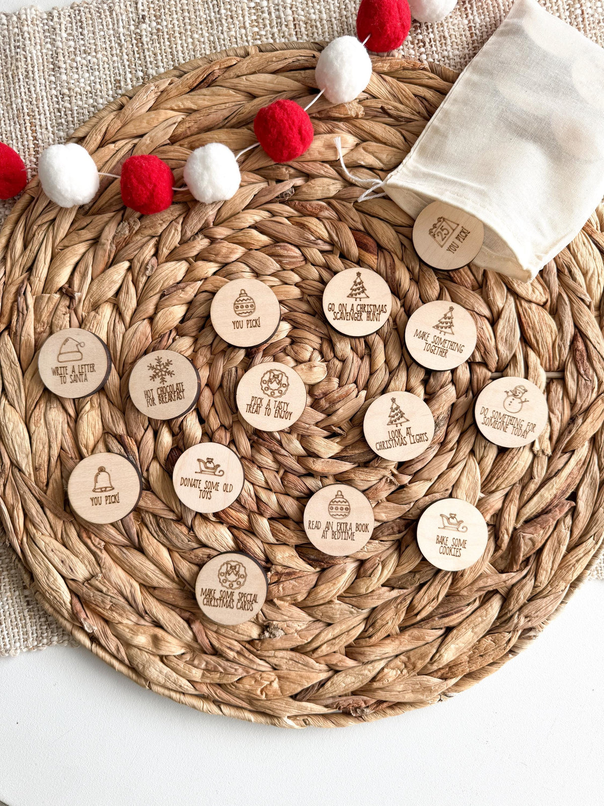 Handmade maple wood Christmas activity coins with a drawstring bag, made in Idaho. A holiday bucket list in token form: pull one each day of December for a family activity, kindness act or Christmas tradition.