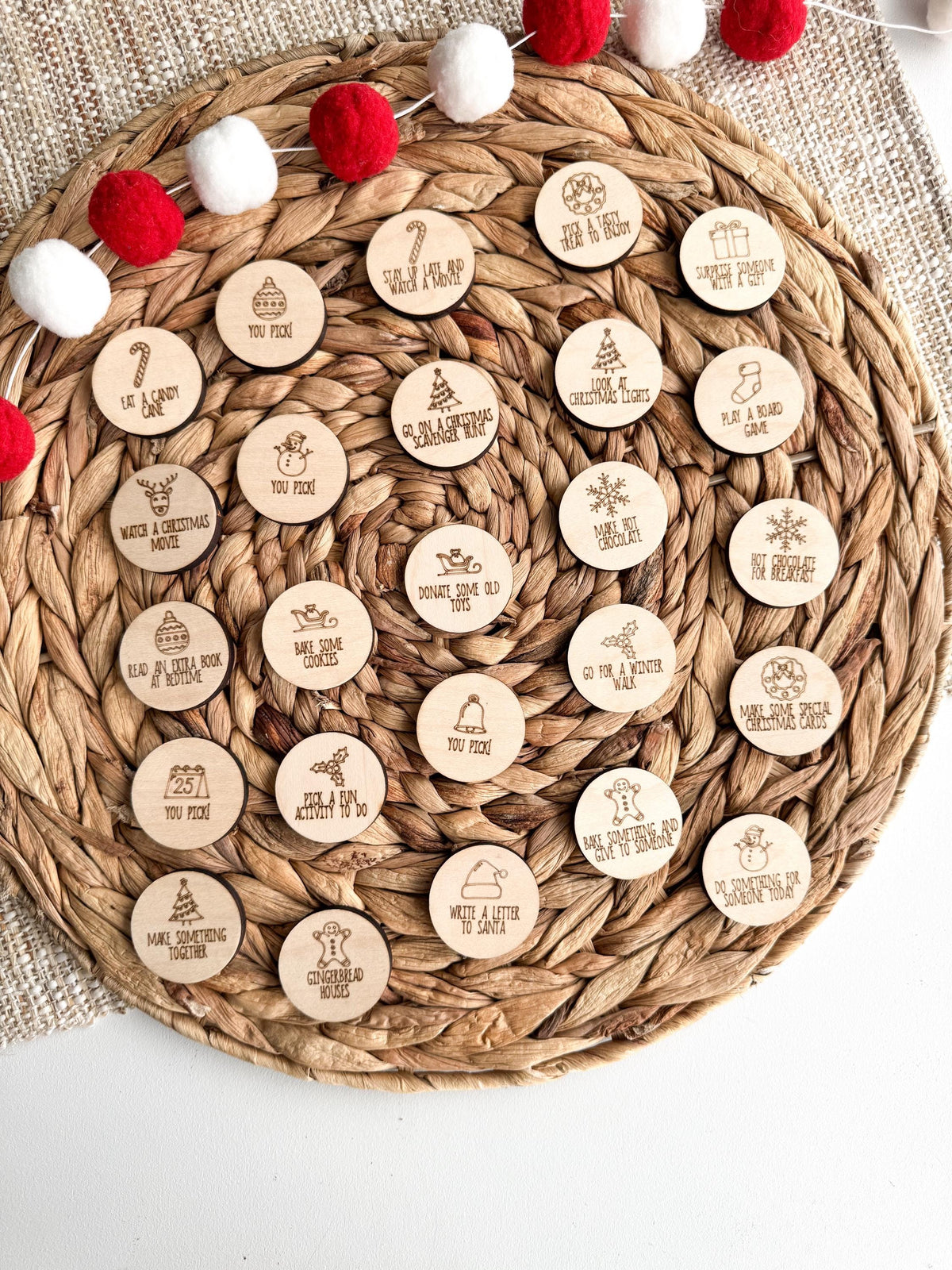 Full set of 25 engraved maple wood Christmas advent tokens with holiday icons and activities, including You Pick! tokens. Wooden advent calendar coins for a no-candy Christmas countdown and family holiday bucket list.