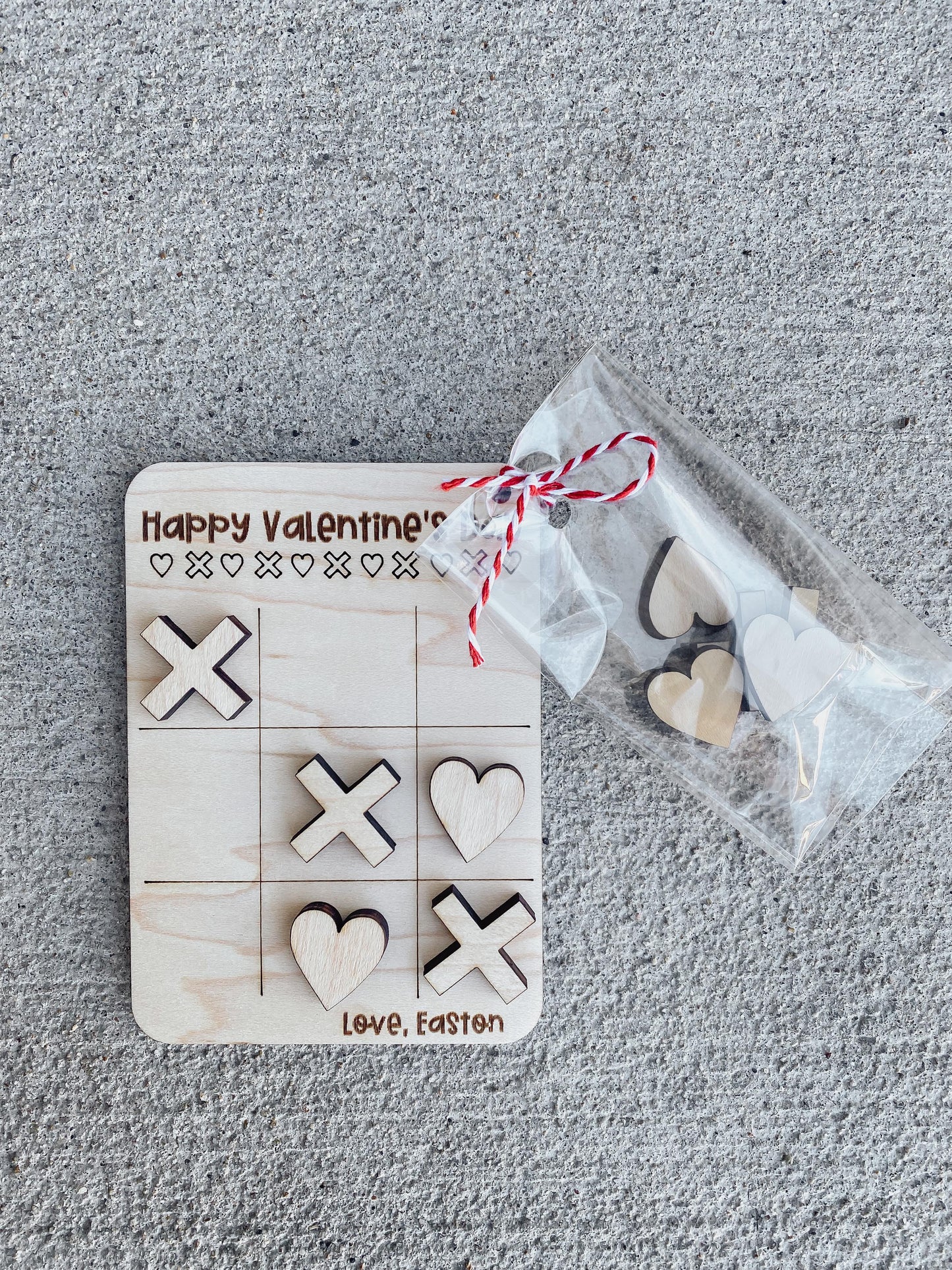 Close-up of tic tac toe Valentine card with game pieces for kids
