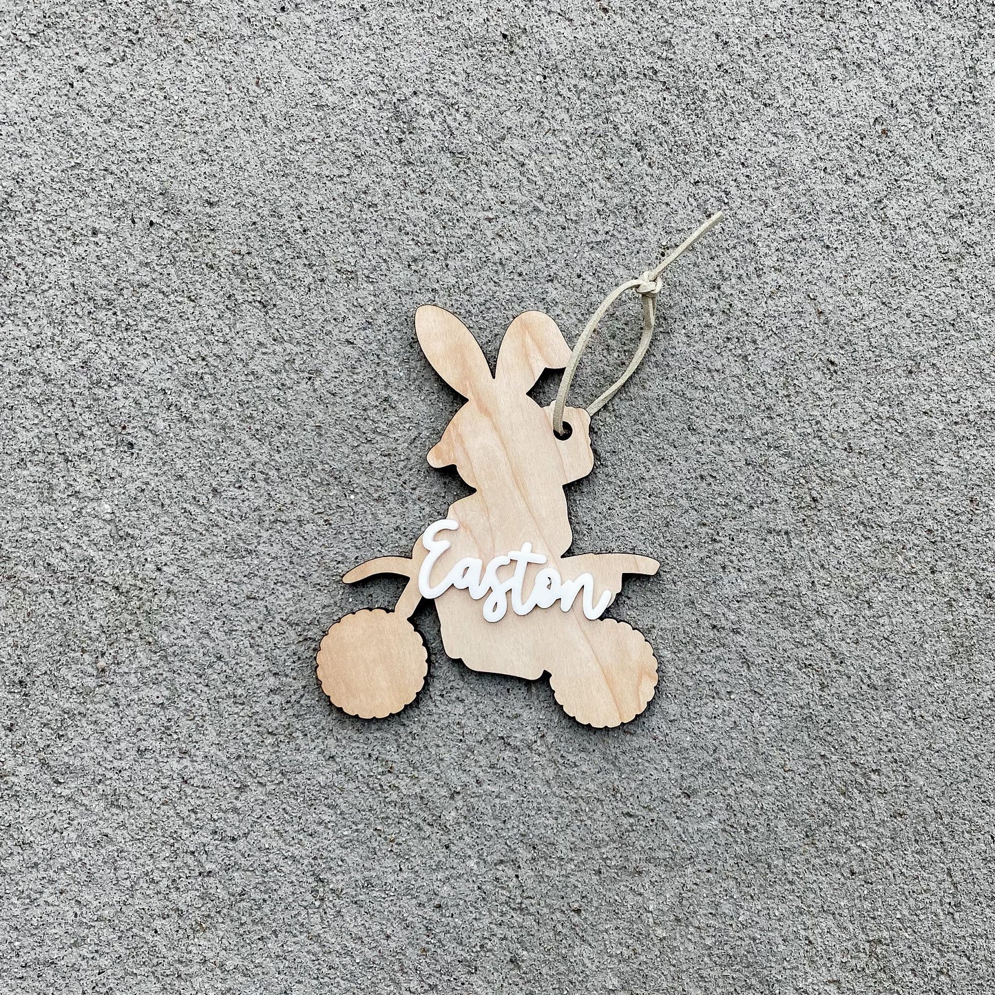 Close-up of dirt bike bunny Easter basket tag with personalized name