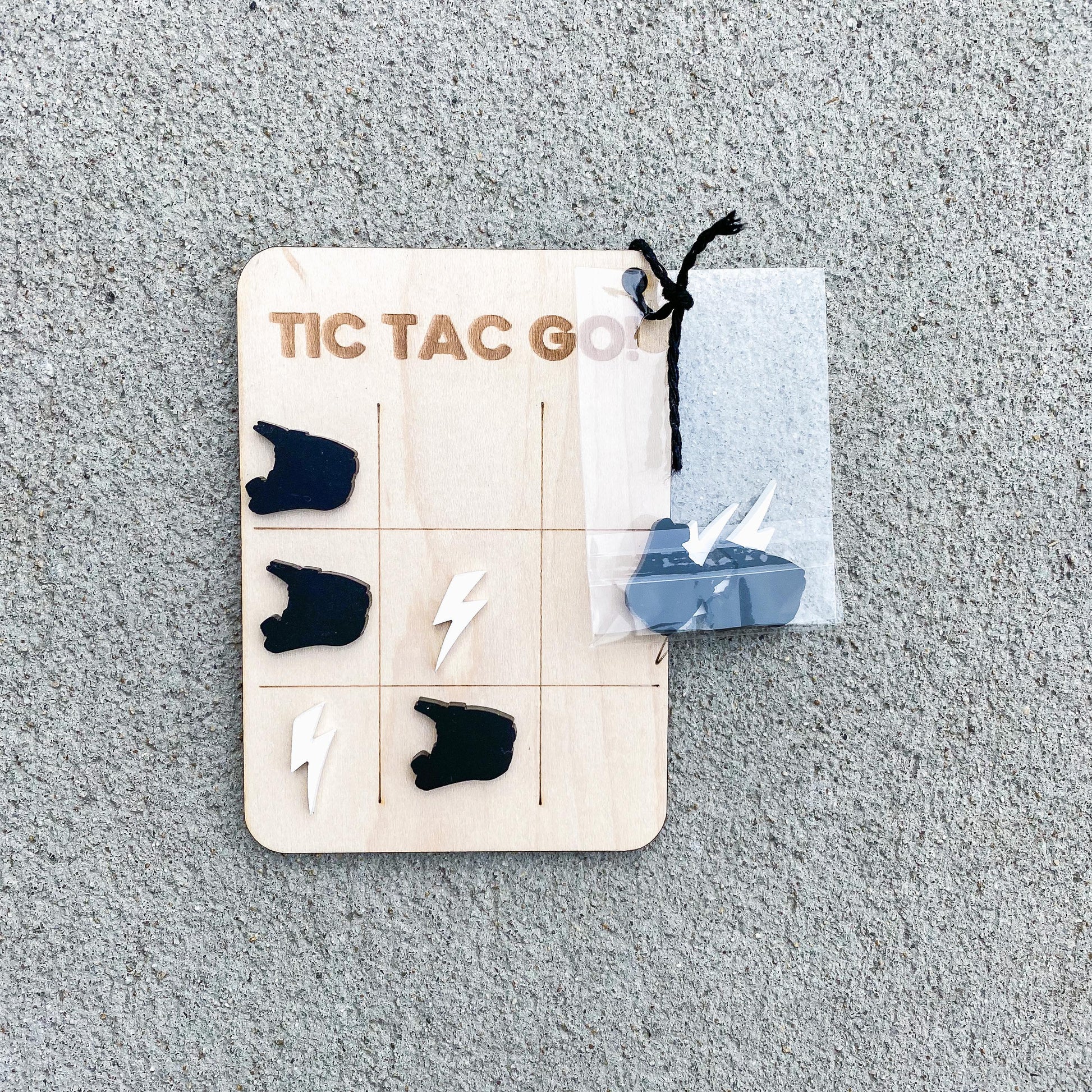 Dirt bike tic tac toe showing game card and pieces, motocross party game for kids