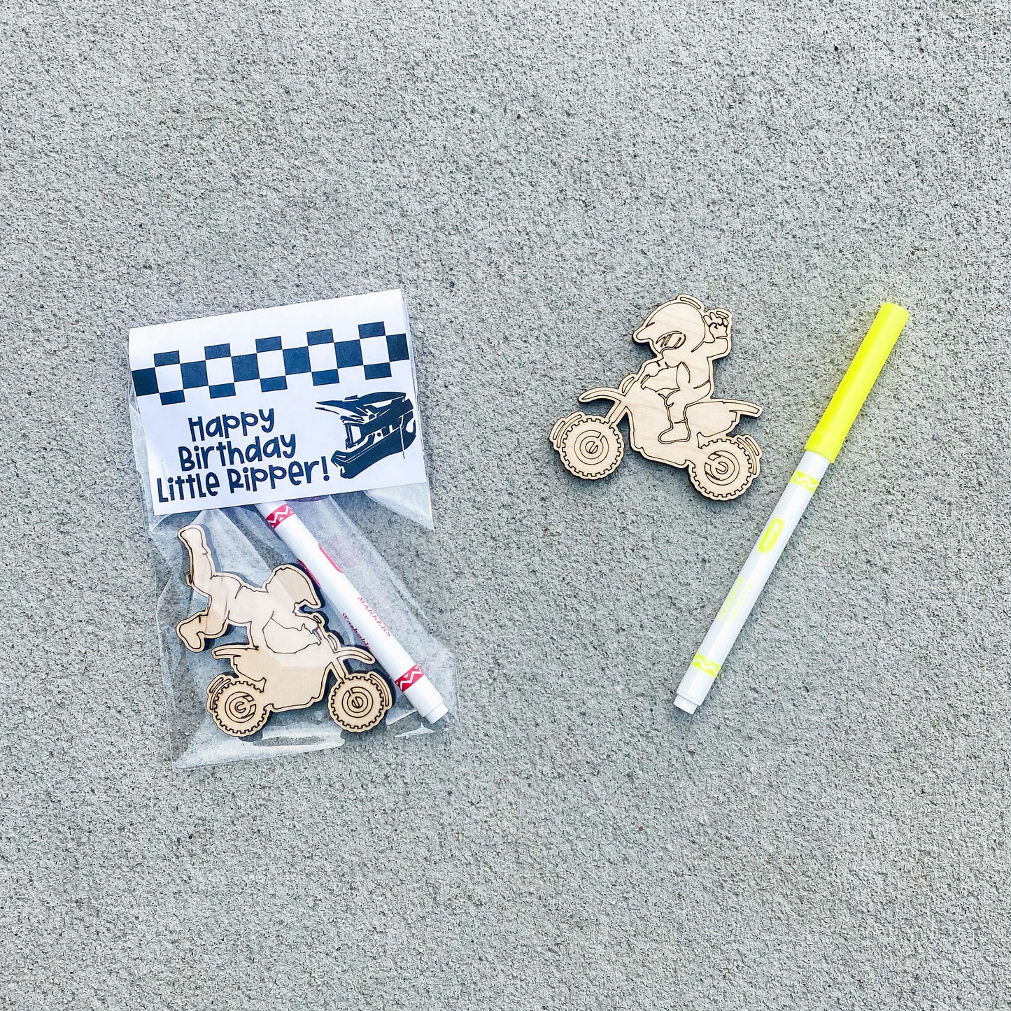Color your own wooden dirt bike birthday party favor with marker and bag